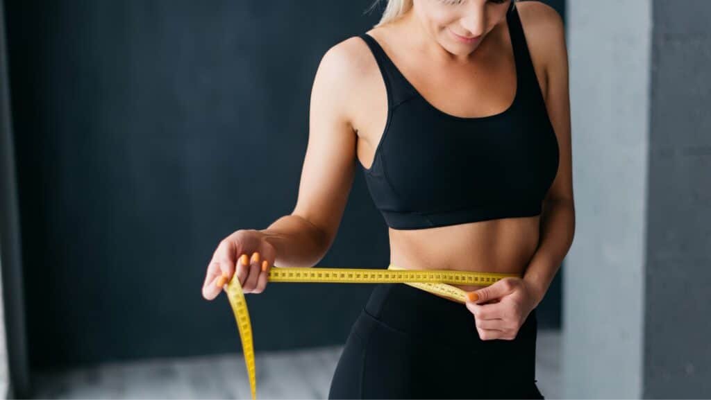 A person measuring her waist