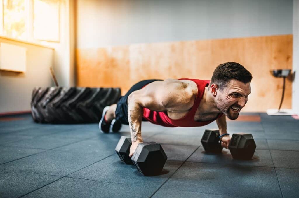 man doing dumbbell pushups