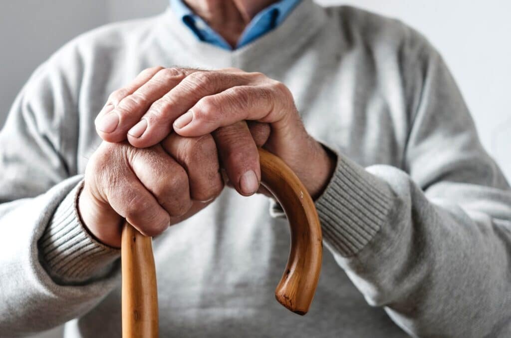 Elderly person with a cane