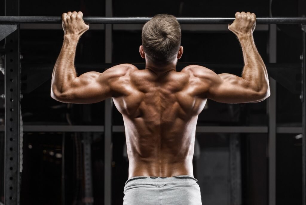 A man doing a pull up shirtless