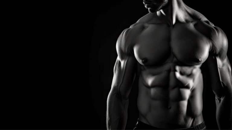 A muscular bodybuilder in a black and white photo.