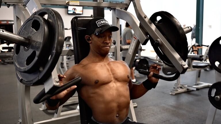 A person working out in a gym performing incline hammer strength press