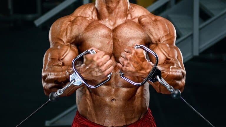 Man performing low cable cross-over for chest muscles