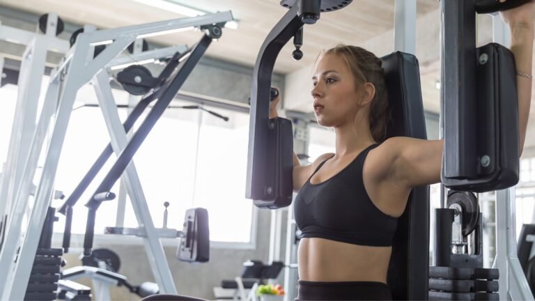 Woman doing chest fly machine